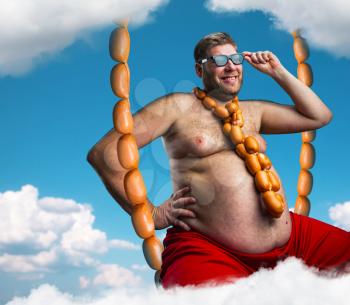 Man sitting on the sausages rope in the sky with sausages round his neck