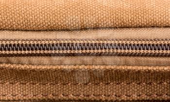 Closeup of brown texture with closed zipper