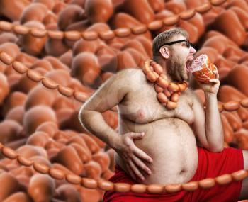 Hungry man with sausages round his neck eats a big wurst over sausages background