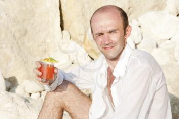 Man with cocktail on the beach
