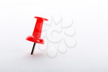 Red push-pin closeup isolated on white background