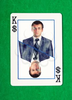 Confident businessman on king of dollars gambling card