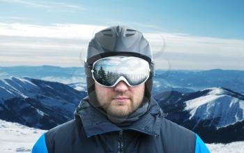 Mountain-skier against mountain with reflection in googles