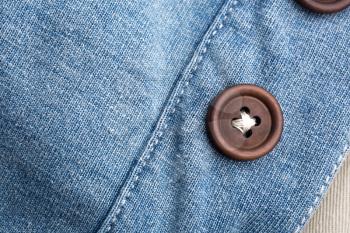 Closeup of jean cloth with plastic buttons