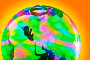 Close-up of colorful glass globe with shining