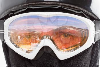 Snowboarder looking at mountains landscape through glasses