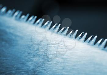 Closeup of saw blade. Toned in blue