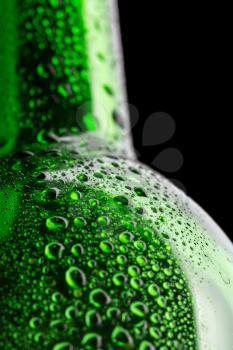 Wet green wine bottle closeup