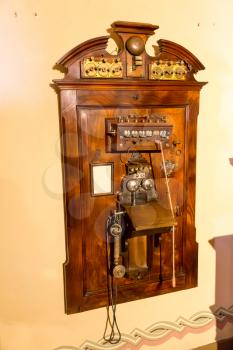 Wooden antique telephone on the wall