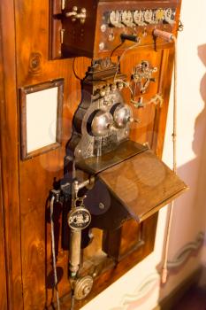 Wooden antique telephone on the wall closeup
