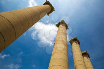 Majestic greek columns against blue sky