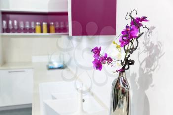 Nice white kitchen interior with orchid flower