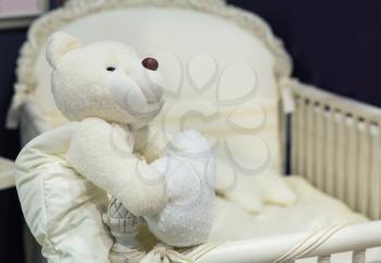 Baby bedroom with white teddy bear on the bed