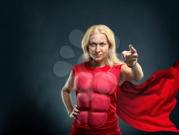 Strong woman superhero pointing to you