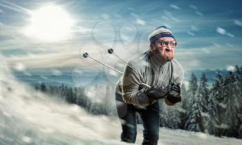 Bearded vintage skier in glasses skiing fast while snowing