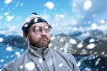 Bearded retro man in glasses in winter mountains 