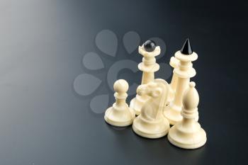 White chess figures on the table over black