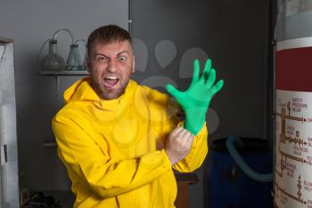 Man in protective outerwear suit wearing rubber gloves preparing to cook meth