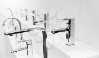 Show-bench with modern bath mixers and taps