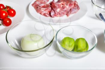 Close up view of ingredients for preparing meat on a white table
