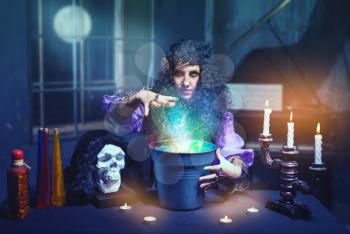 Sorceress practises witchcraft using bucket bucket and skull
