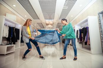 Young women fighting for a jacket in the shop