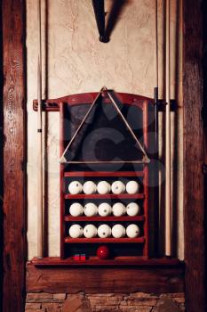 Billiard set: balls, triangle, pool sticks on the stand