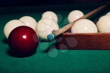 Billiard balls prepared for play and wooden triangle close up view