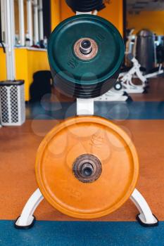 Close up of weight plates on the bar-bells in the gym