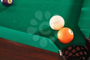 Above view on two billiard balls opposite to a pocket. Angle of the billiard table.