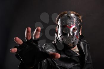 Serial maniac in hockey mask and cutted leather gloves  background.