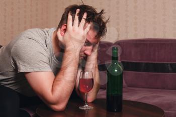 Stressed man after hard drinking. Alcohol abuse problem concept.