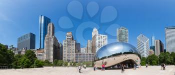 Chicago, Illinois, USA - June 14, 2016. Cloud Gate sculpture in Millenium park. One of the most unique and interesting sculptures. Author Anish Kapoor. Panorama cityscape.