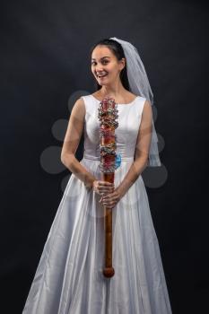 Serial murederer in wedding dress with bloody bat
