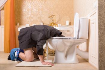 Man with pants down sick in the toilet bowl. Bathroom interior in vantage style on background