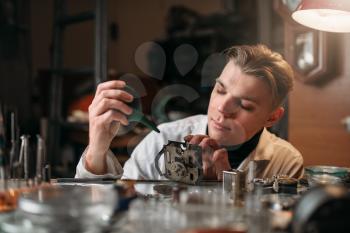 Watchmaker cleans the mechanism of old watches. Clock maker at work
