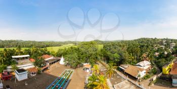 Village in a tropical forest on Ceylon panorama view. Landscape of Sri Lanka