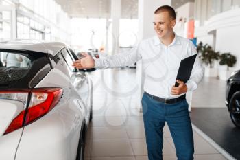 Salesman shows new car in showroom. Male customer buying vehicle in dealership, automobile sale, auto purchase