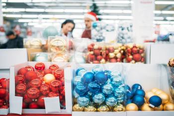Department of holiday decorations in supermarket, family tradition. December purchasing of new year or christmas goods