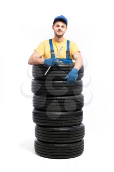 Car tire service repairman, white background, garage worker with tyres, wheel mounting