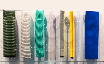 Corrugated plastic tubes and rubber water hoses, plumbing shop showcase