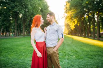 Romantic date, love couple hugs together, meeting in summer park. Attractive woman and young man leisure outdoors