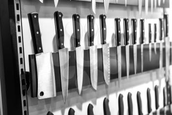 Kitchen knives collection on magnetic holder closeup. Cooking equipment