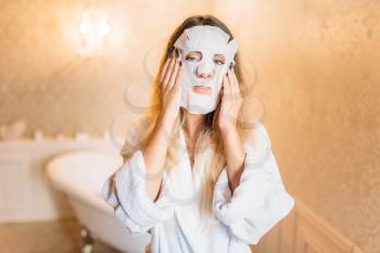 Woman with facial cosmetic mask, skincare in bathroom. Bodycare and hygiene, healthcare, beauty products
