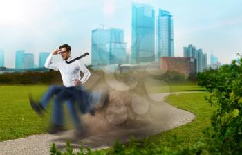 Purposeful and confident businessman runs the way to victory, legs with blur repeating effect, cityscape on background. Fast track to success concept
