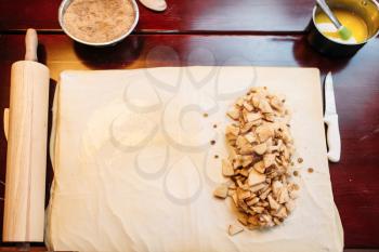 Apple strudel ingredients on wooden kitchen table, top view, nobody. Homemade sweet dessert, pastry preparation