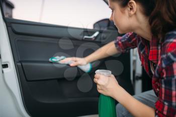 Wet cleaning of the interior of the car on carwash. Lady on self-service automobile wash. Outdoor vehicle cleaning