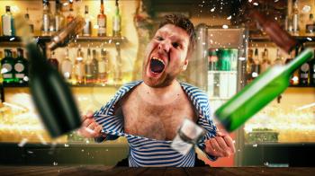 Drunk bartender tears his vest at the bar counter. Crazy party in full swing, unforgettable fun, celebration