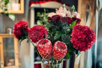 Fresh red flower bouquet closeup, nobody. Floral composition in boutique, floristic business