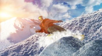 Snowboarder makes a jump, front view, sportsman in action. Winter active sport, extreme lifestyle. Snowboarding in mountains